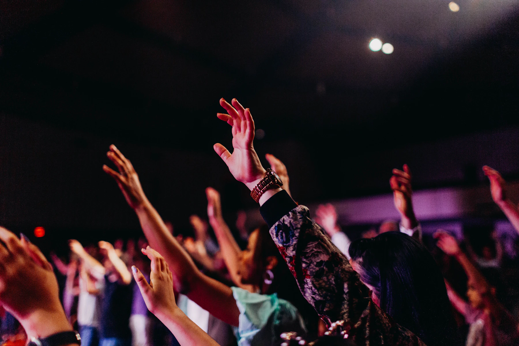Worshippers raising their hands during praise